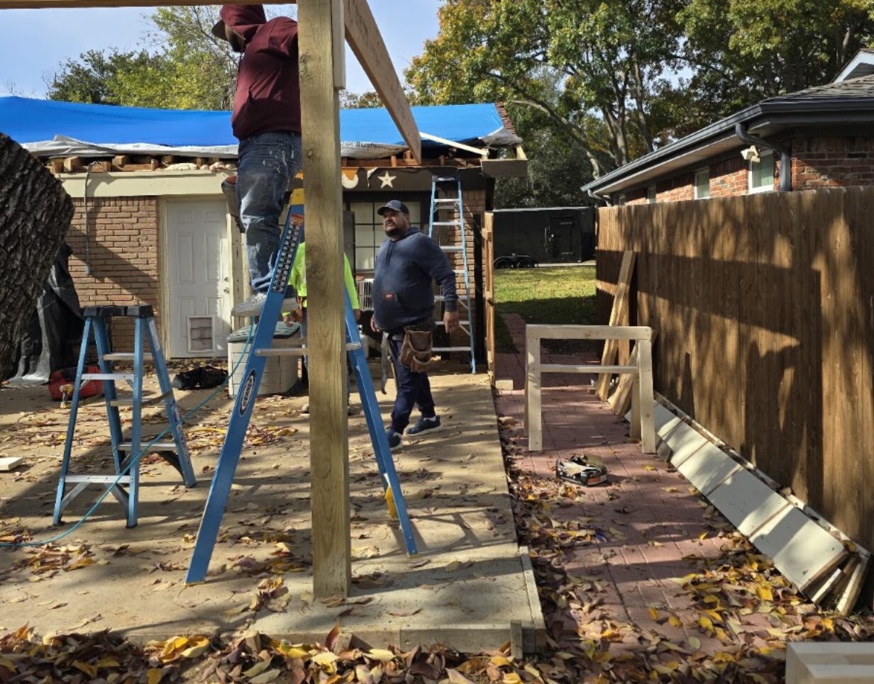 Home Glow Exteriors crew building a custom wood fence and patio cover